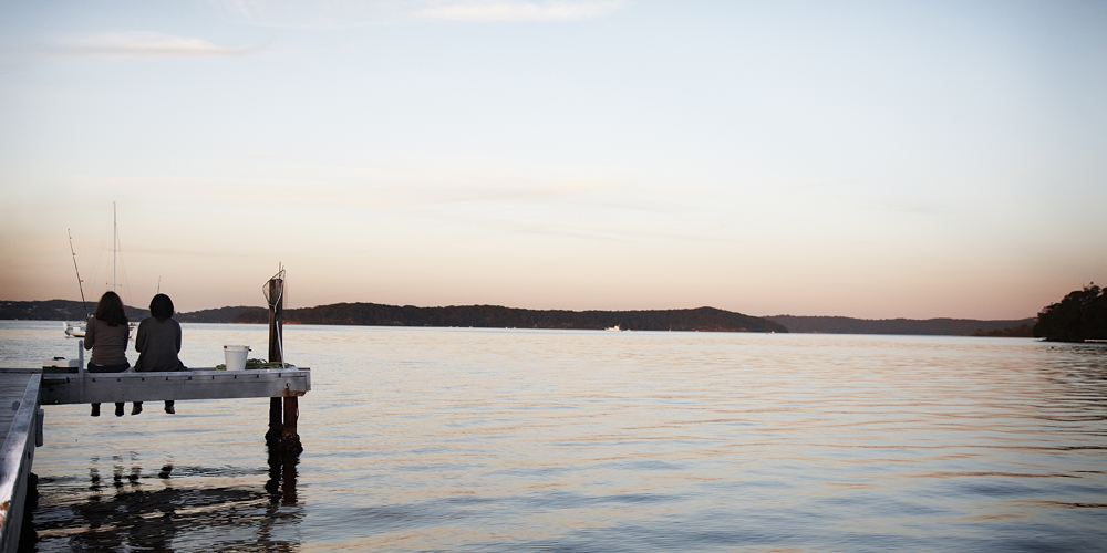 girls sitting on jetty