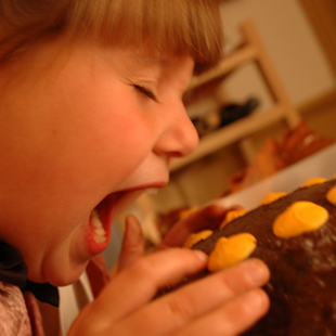 young girl eats cake